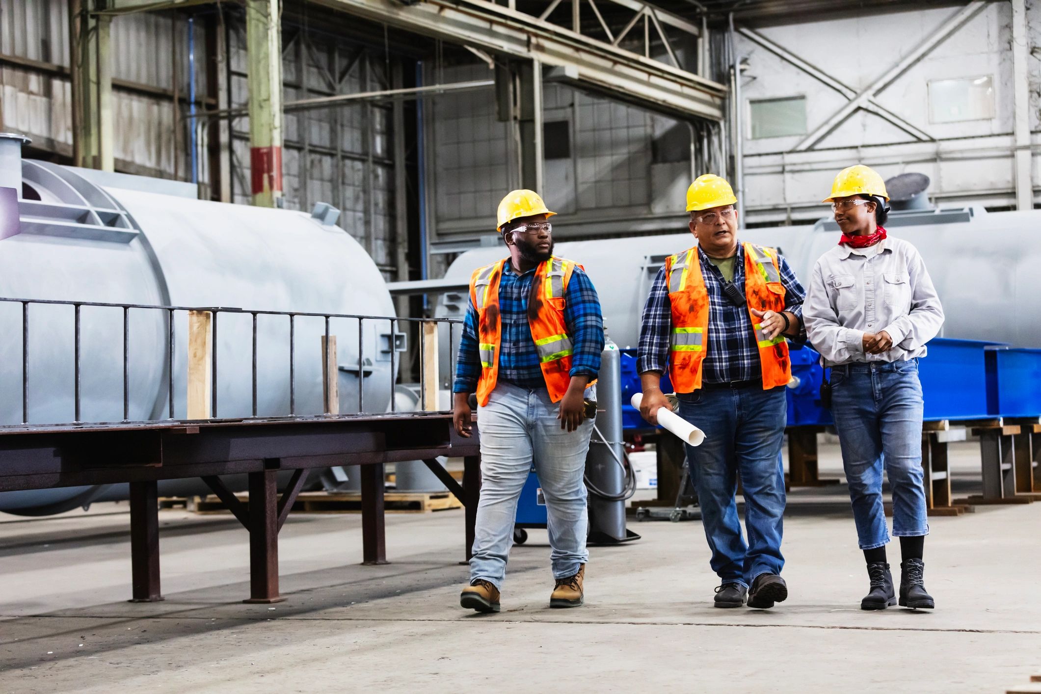 Construction professionals coordinating work in an industrial setting