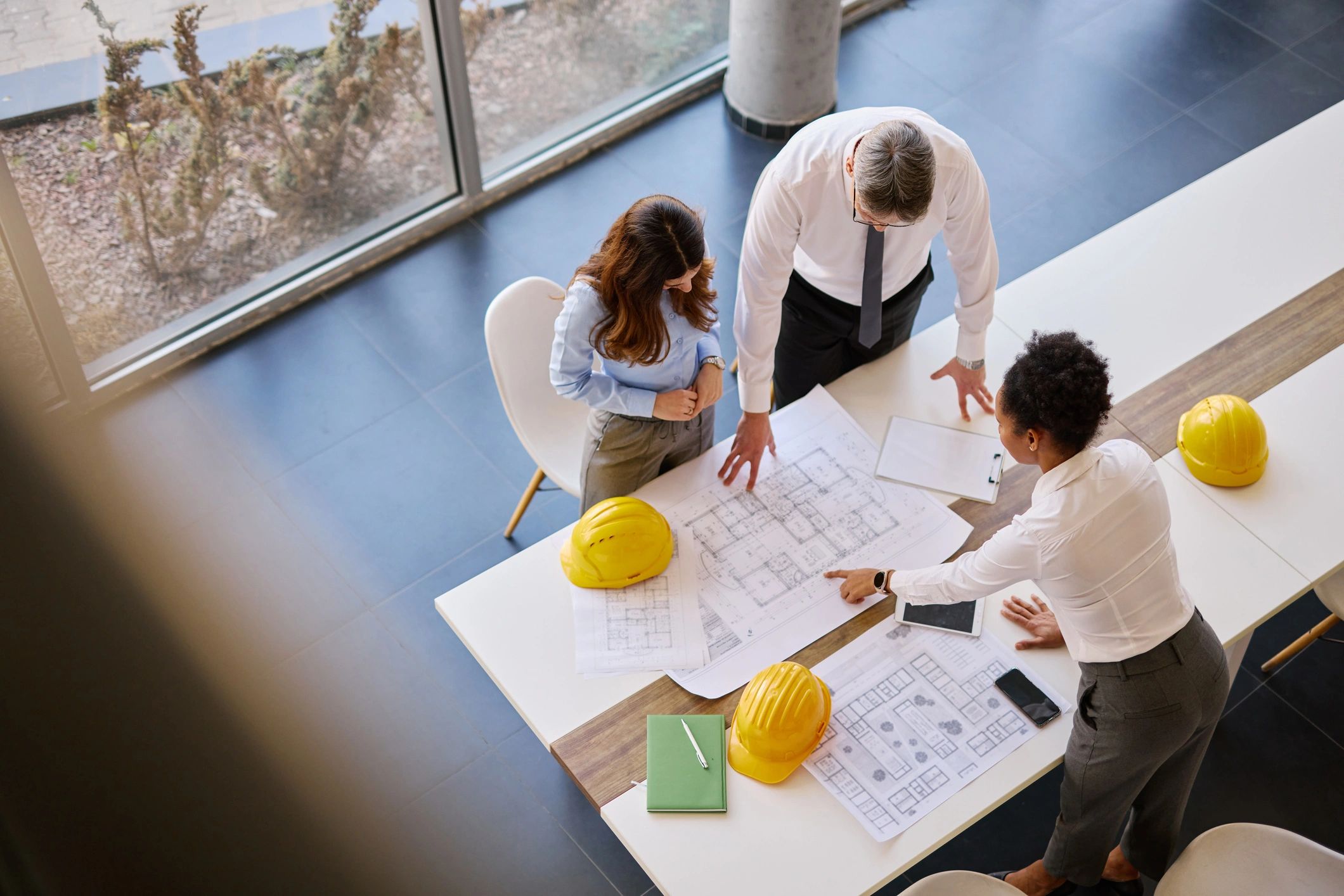 Team reviewing construction drawings during pre-construction planning